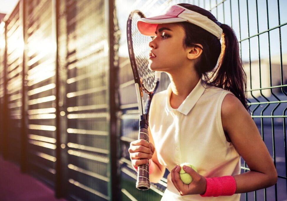 Sport young woman on tennis court. Female tennis player.